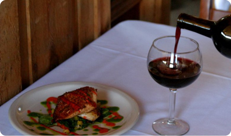 A view of the water and wine from inside of Four Winds Steakhouse.